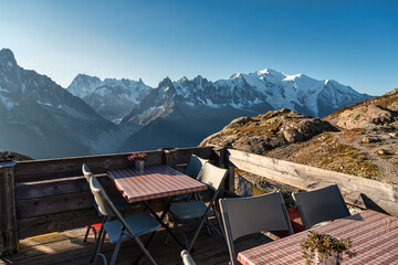 View of Mont Blanc massif with table, chair on patio in Lac Blanc at French Alps - obrazy, fototapety, plakaty
