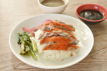slice roasted duck topping rice with pink pickled ginger and boiled cabbage dressing sweet soy sauce on plate