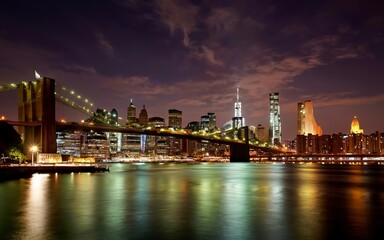 Panorama of downtown Manhattan and the Brooklyn bridge at night from Brooklyn in NYC - obrazy, fototapety, plakaty
