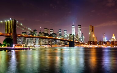 Panorama of downtown Manhattan and the Brooklyn bridge at night from Brooklyn in NYC