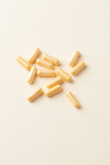 Coenzyme Q10 capsules. Dietary supplements. Bright paper background. Top view. Copy space.	