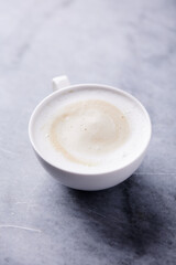 Cup of Coffee on bright stone background. Close up.	