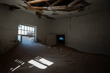 Inside of an abandoned building with damaged walls in an old desert town