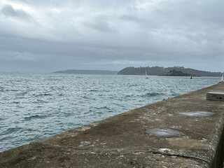 Plymouth sound sea on a grey winters day with sailing yacht in the United Kingdom. 