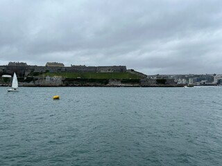Plymouth sound sea on a grey winters day with sailing yacht in the United Kingdom. 