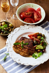 Grilled pork steak with fresh salad. Close up.
