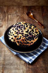 Simple Cake with Bilberries on wooden background. Front view. Close up	