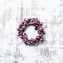 Christmas Wreath on bright wooden background. Top view. Copy space.
