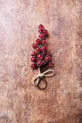 Christmas branch on rustic stone background. Top view. Copy space.
