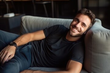 Portrait of a smiling man relaxing on the sofa