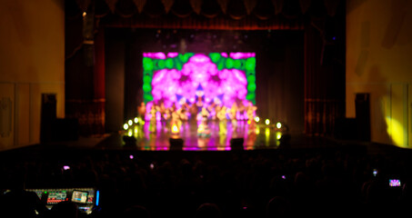 blur background, texture for design. Spotlights in the concert hall and screen on the background.