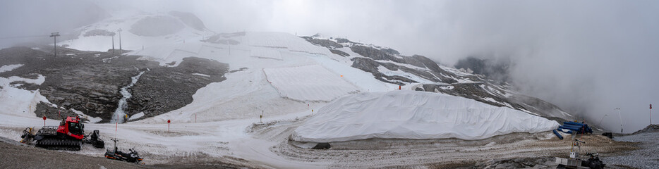 A large snow tarpaulin protecting the ice of the Hintertux glacier in the Alps, a ski slope is...