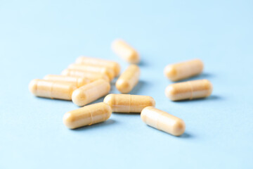 Coenzyme Q10 capsules. Dietary supplements. Bright paper background. Close up.	