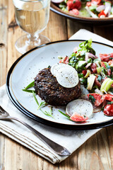 Fried hamburger steak with fresh salad. Wooden background. Close up.	