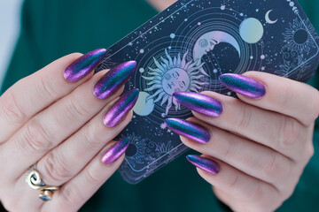 Female hands holding tarot cards for fortune telling and tricks