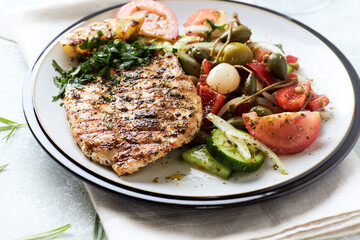 Grilled Turkey Breast with fresh salad. Bright background.	