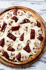 Pizza with mozzarella cheese, and marinated tomatoes . Dark wooden background. Top view.	