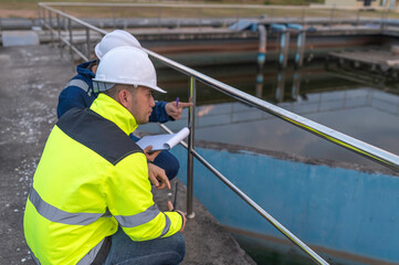 Environmental engineers work at wastewater treatment plants,Water supply engineering working at Water recycling plant for reuse,Technicians and engineers discuss work together.