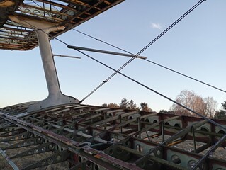 The frame of the wing of an old single-engine plane. An old non-working plane on the background of the sky. The topic of old abandoned aviation equipment.