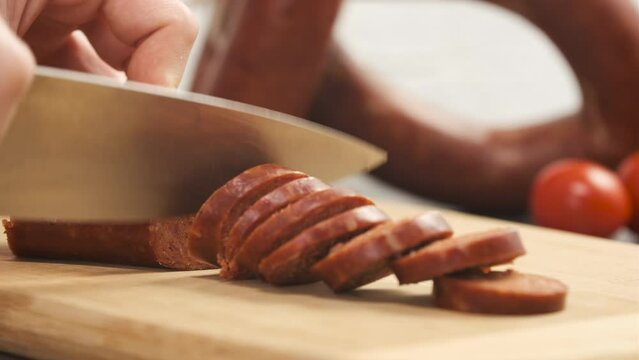 Slicing Turkish Sausage Also Known as Sucuk in Pan. Cutting Meat to Roast. Preparing for Breakfast Close Up Shot Slow Motion. Camera Sliding Left to the Right. 