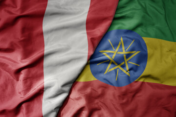 big waving national colorful flag of ethiopia and national flag of peru .