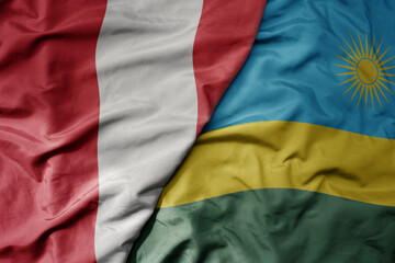 Fototapeta premium big waving national colorful flag of rwanda and national flag of peru .
