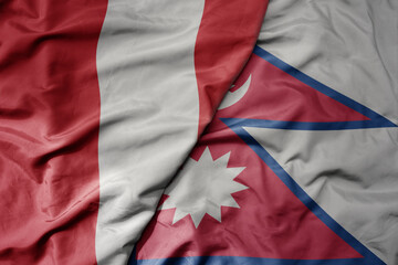 Fototapeta premium big waving national colorful flag of nepal and national flag of peru .