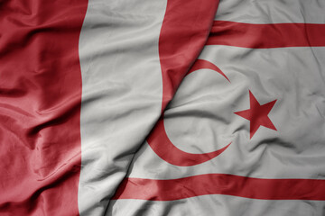 big waving national colorful flag of northern cyprus and national flag of peru .