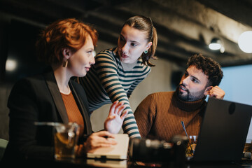 Successful business team analyzing sales statistics and planning project for revenue growth in corporate office.