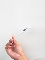 hand holding thermometer white background