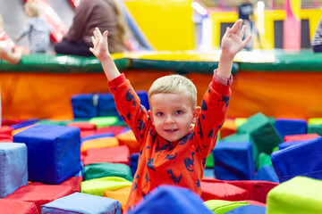 Fototapeta na wymiar Young Boy Playing in Colorful Soft Play Area