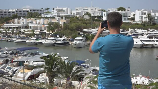 Tourists taking pictures with photo camera in Cala d'Or Mallorca