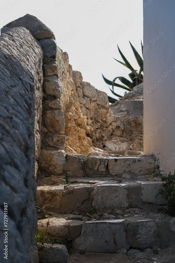 Wall mural Romantic backstreet, side street and alleys in historic old town of Ibiza Stadt, Balearic Island with historic Mediterranean style architecture facades, a landmark sightseeing tourist spot in downtown