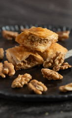 Turkish Traditional Dessert Baklava with Walnut on Stylish Plate. Close Up Vertical Shot.
