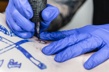 Horizontal photo detailed work of a tattoo artist at close range. Concept business, art.