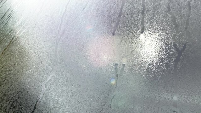 a condensation dew glass car water wet windshield window rain rainy mist moist vehicle drops moisture fog transparent light closeup video clean stream condensate climate humid drip motion closeup drop