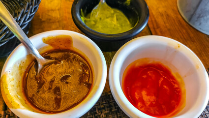 3 sauces green coriander red ketchup and barbecue Mexico.