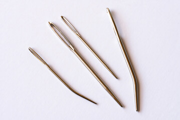 Various Sized Yarn Needles on White Background
