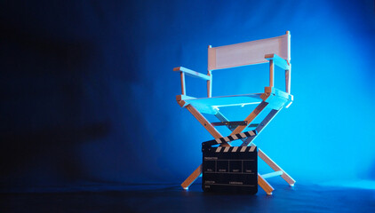 Director chair in blue light with black clapper board .
