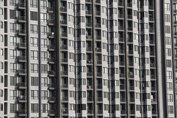 Close up of tall building with a skyscraper background.