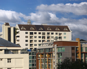Top of a tall building with a blue sky background at daytime.