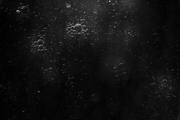 Air bubbles in the water background.Abstract oxygen bubbles in the sea.Water bubbles isolate on black background.Black and white tone style.
