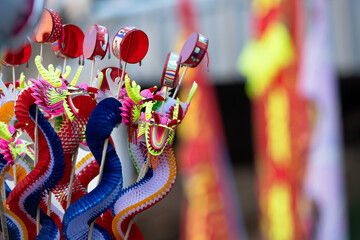 Colorful Chinese dragon toys in Chinese New Year festival.Chinese New Year Decoration, Dragon toy paper on festive background. © arcyto