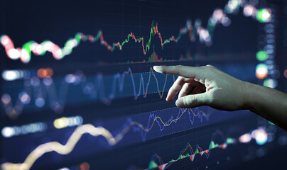 Businessman hand analysing financial stock market graph on board. Trading data index investment...