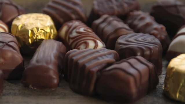 Assorted chocolates pralines with smooth rotation motion close up view	