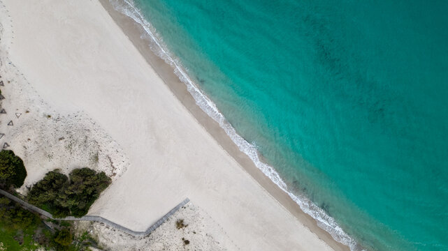 Aerial drone shots of the port of Teulada with Isola Rossa and Tramatzu beach with white sand and crystal clear water.