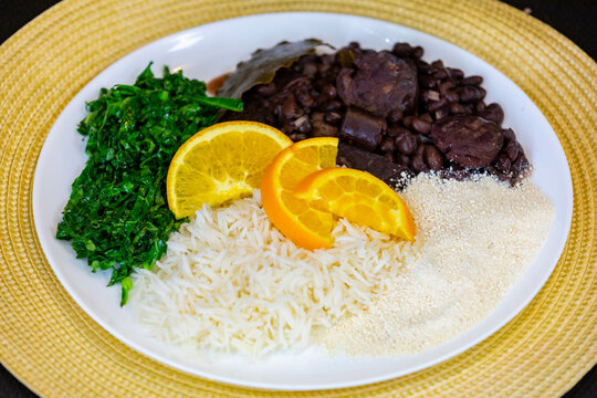 Traditional Brazilian feijoada served on a white round plate