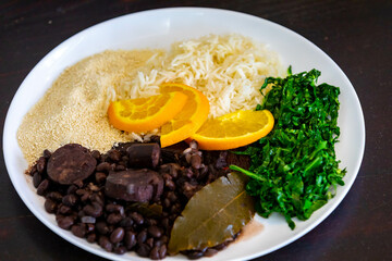 Traditional Brazilian feijoada served on a white round plate