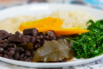 Traditional Brazilian feijoada served on a white round plate