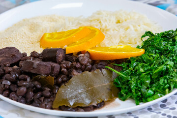 Traditional Brazilian feijoada served on a white round plate